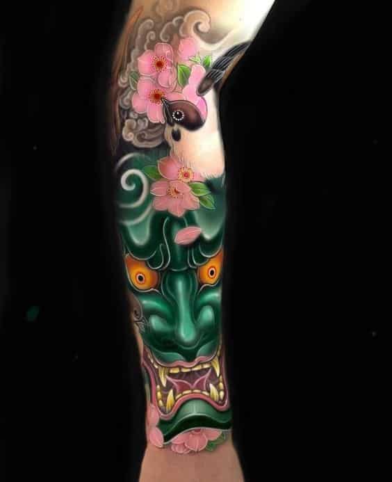 mau-tattoo-mat-quy-xanh-ket-hop-hoa-dao-hong-tinh-te mẫu tattoo mặt quỷ xanh kết hợp hoa đào hồng tinh tế